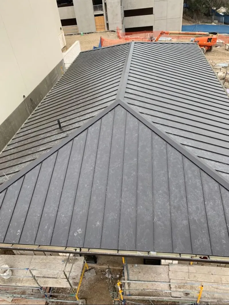 Commercial metal roof construction with crane equipment in Mead Valley