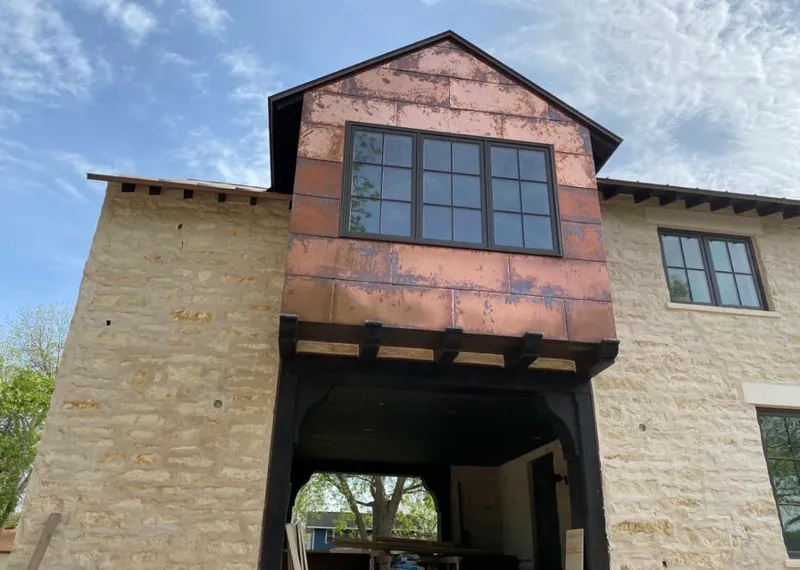 Copper metal panel facade on a stone building for Skylight Installation in Mead Valley